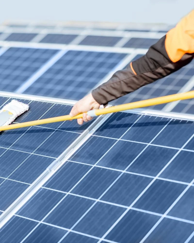 Solar panel cleaning with a long-handled tool