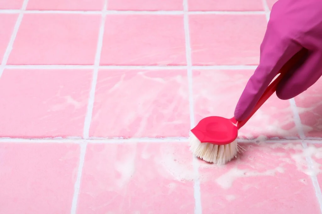 A brush working along tile grout lines